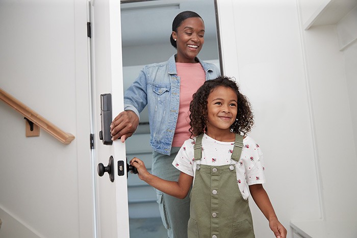 mom-and-daughter-entering-home-through-garage-door