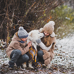 children-walking-in-park-with-pet-dog-during-winter-250