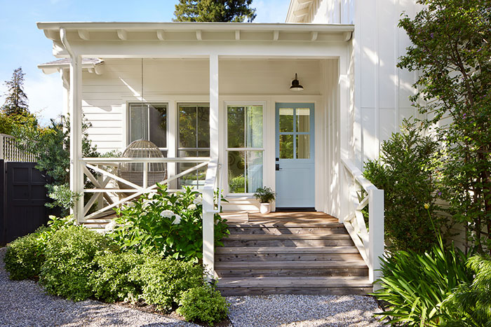 white-bungalow-front-porch-ideas-with-coastal-blue-front-door